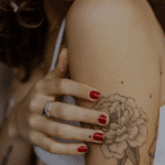 A woman with a japanese flower tattoo.